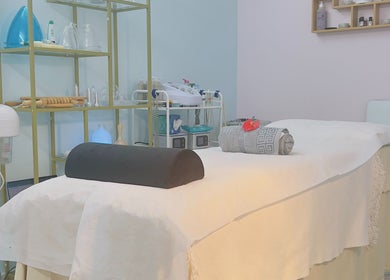 Massage room at Diddy's Beauty & Wellness, London, England, GB, featuring a cozy treatment bed and soothing decor.