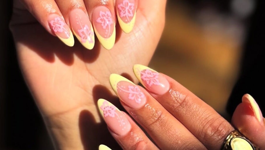 Floral nail art with yellow tips at The Nail Room in North Branch, Minnesota, US.