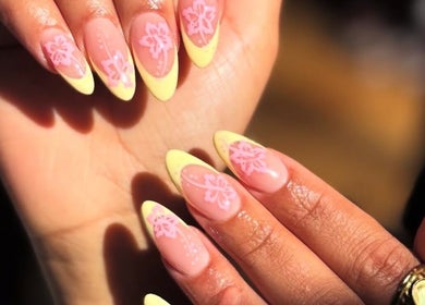 Floral nail art with yellow tips at The Nail Room in North Branch, Minnesota, US.