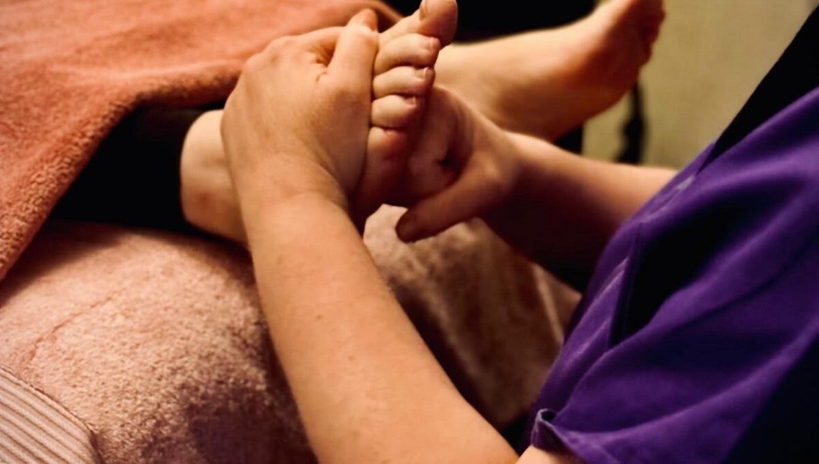Foot massage at Reforkology in Sarn, Wales, GB, highlighting relaxation and wellness.