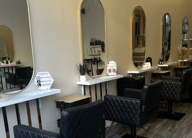 Elegant interior of Eleven Eleven Salon in Stirling, Scotland, GB, showcasing modern styling stations and mirrors.