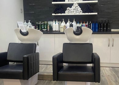 Modern wash stations at Eleven Eleven Salon, Stirling, Scotland, GB, featuring sleek chairs and stylish decor.