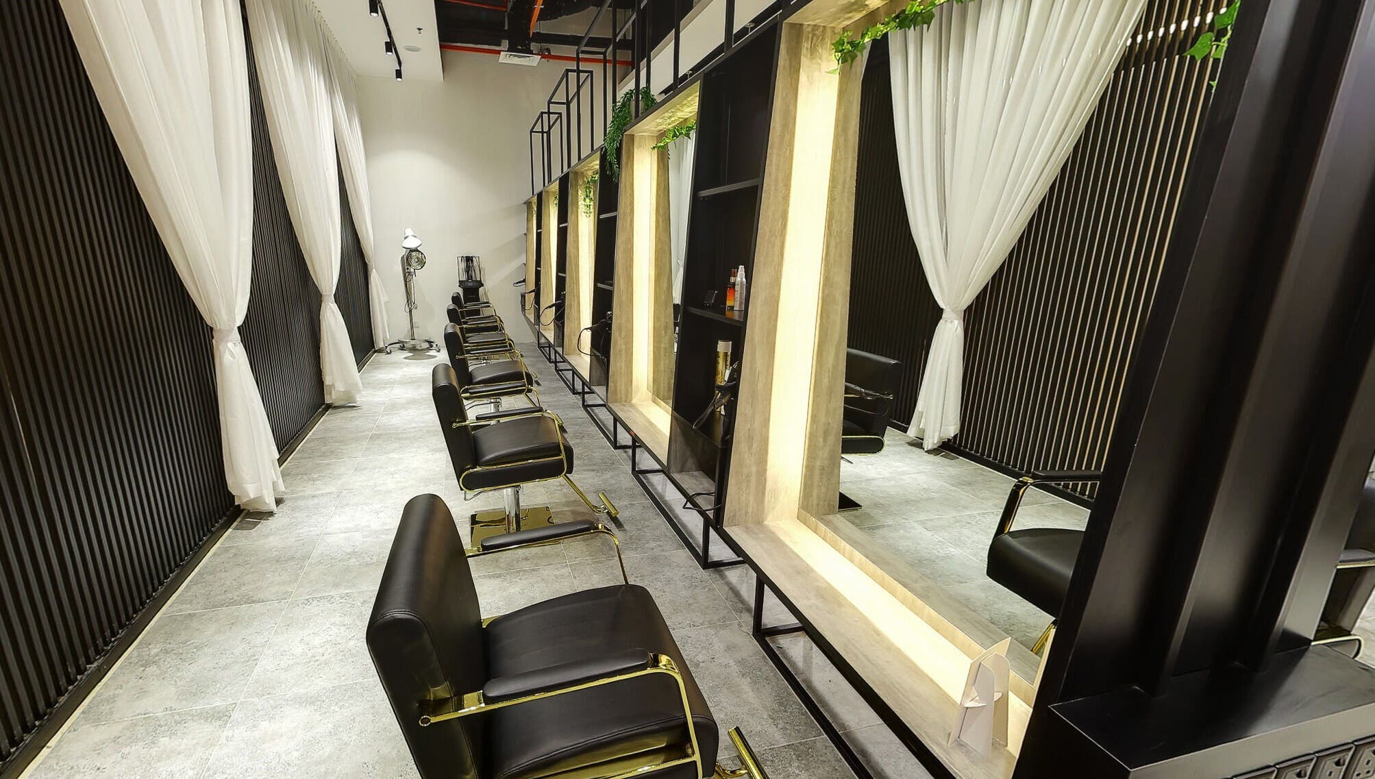 Chic salon interior at Hairover Salon, IOI Mall Damansara, Petaling Jaya, Selangor, MY with sleek black chairs.
