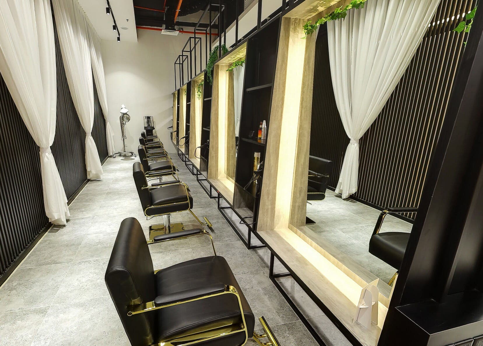 Chic salon interior at Hairover Salon, IOI Mall Damansara, Petaling Jaya, Selangor, MY with sleek black chairs.