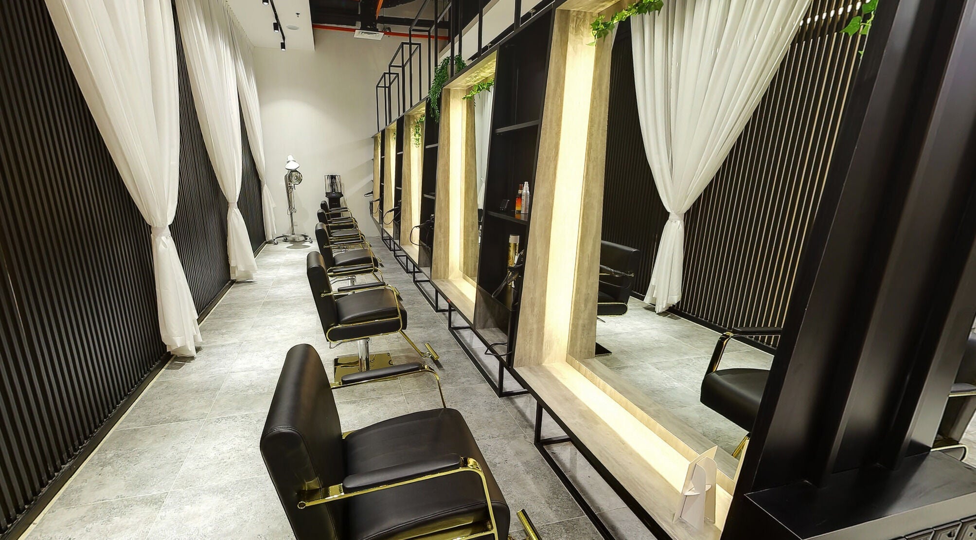 Chic salon interior at Hairover Salon, IOI Mall Damansara, Petaling Jaya, Selangor, MY with sleek black chairs.