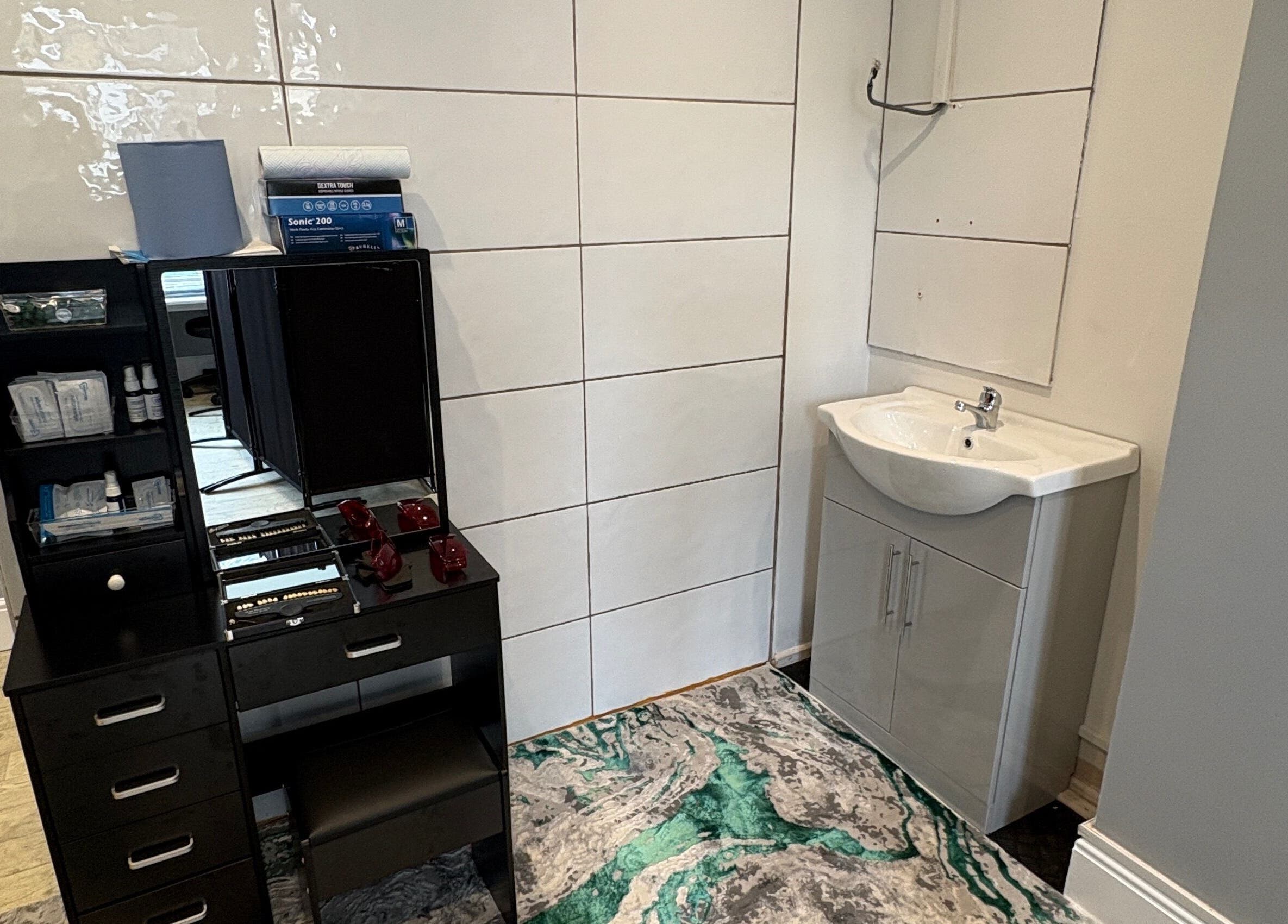 Modern sink area at Norfolk & Suffolk Teeth Whitening Services in Cromer, England, GB, showing sleek design.