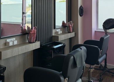 Modern salon interior at Georgia Rose Hair Extensions, Bournemouth, England, GB with chic styling chairs.