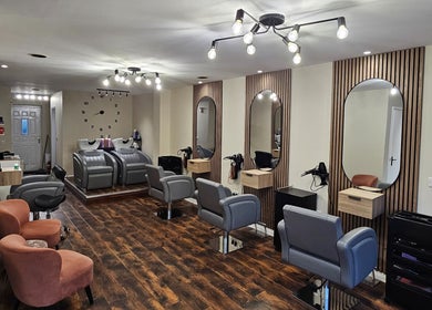 Elegant interior of Our Hair Lounge in Eastleigh, England, GB with modern styling stations and lighting.