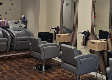 Modern salon interior at Our Hair Lounge, Eastleigh, England, GB. Featuring stylish chairs and mirrors.