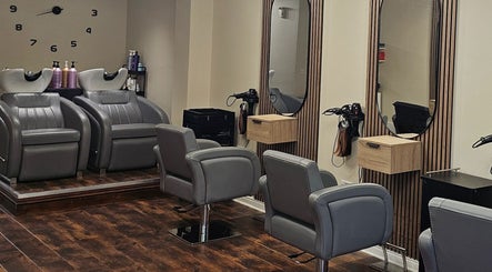 Modern salon interior at Our Hair Lounge, Eastleigh, England, GB. Featuring stylish chairs and mirrors.