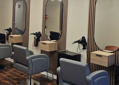 Modern salon interior at Our Hair Lounge, Eastleigh, England, GB with stylish seating and mirrors.