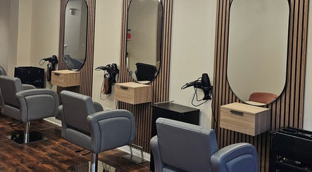 Modern salon interior at Our Hair Lounge, Eastleigh, England, GB with stylish seating and mirrors.