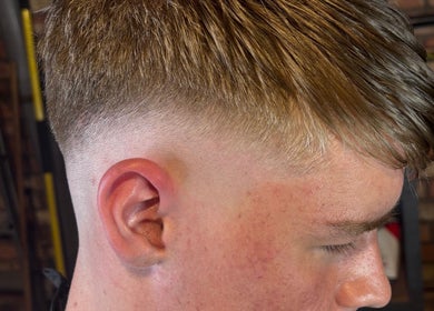 Side view of a stylish haircut at The Garage Chair, Cherry Burton, England, GB.