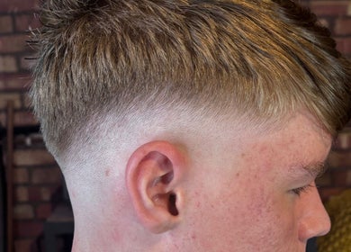 Close-up of a man's crisp fade haircut at The Garage Chair in Cherry Burton, England, GB.