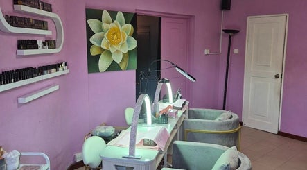 Nail salon at Revival Spa, Victoria, Beau Vallon, SC with purple decor and soothing lotus artwork.