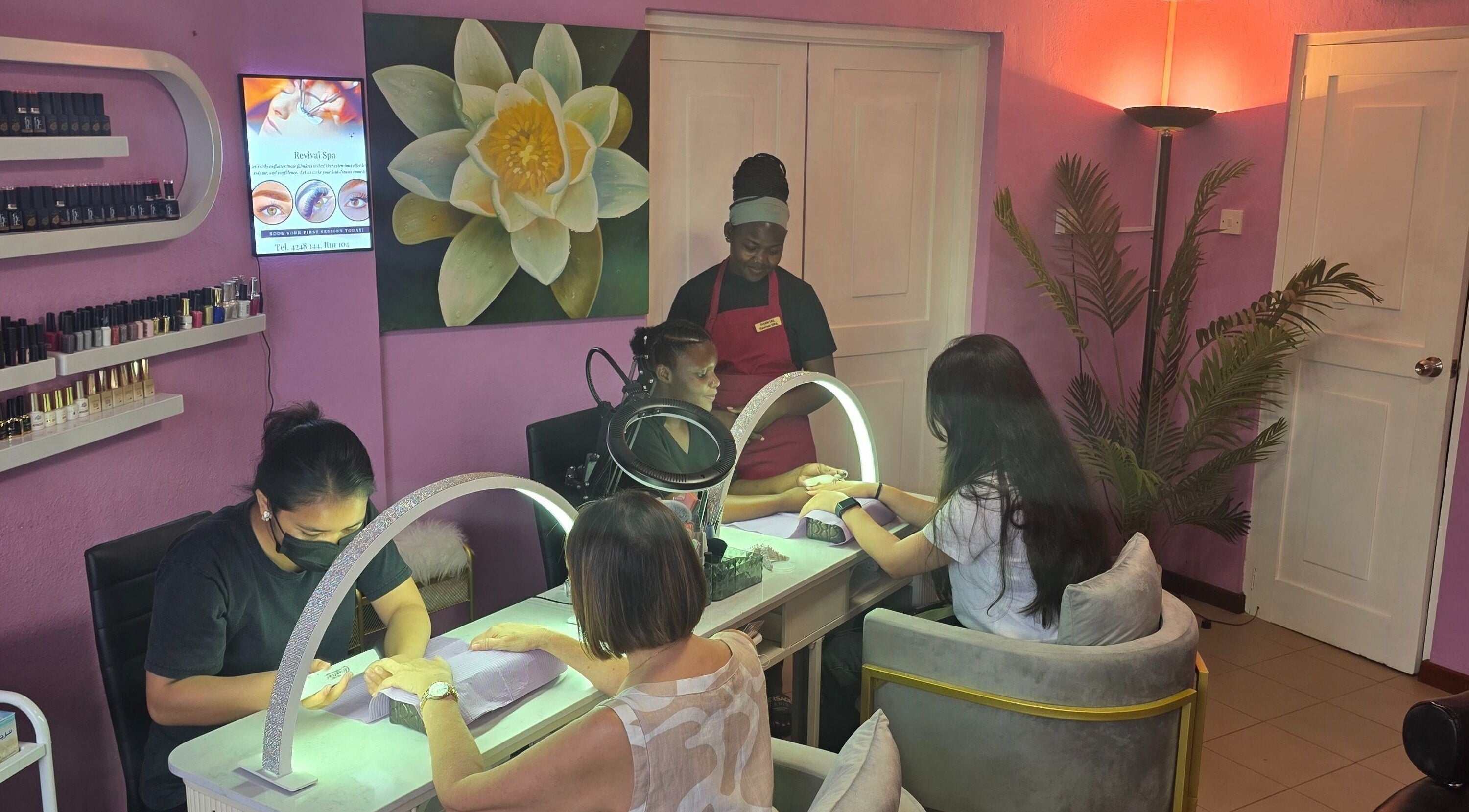 Guests enjoy manicures at Revival Spa, Victoria, Beau Vallon, SC, in a serene lavender-hued setting.