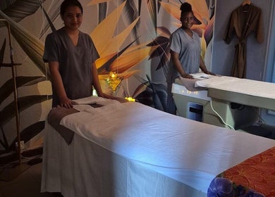 Massage therapists at Revival Spa, Victoria, Beau Vallon, SC, in a tranquil treatment room.