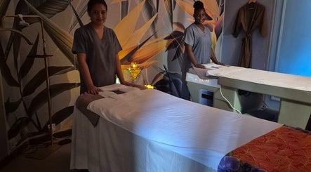 Massage therapists at Revival Spa, Victoria, Beau Vallon, SC, in a tranquil treatment room.