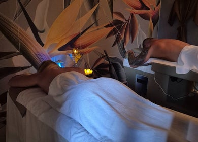 Relaxing massage session at Revival Spa, Victoria, Beau Vallon, SC, with ambient lighting and artistic decor.