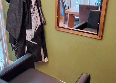 Styled corner with mirror and chair at TasHair salon, Blacon, England, GB.