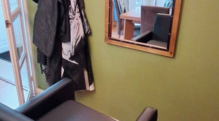 Styled corner with mirror and chair at TasHair salon, Blacon, England, GB.
