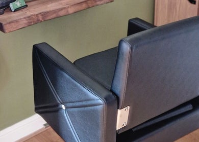 Modern black salon chair at TasHair in Blacon, England, GB, enhancing the chic interior.