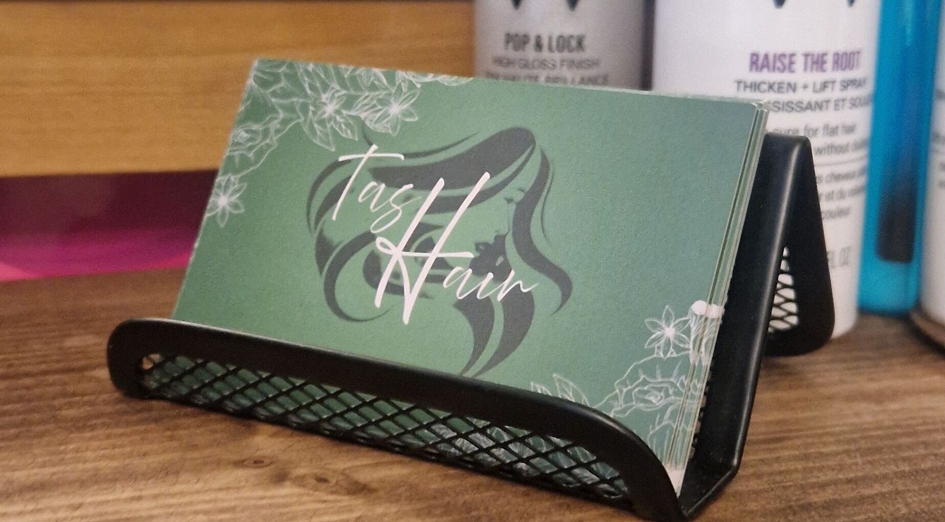 Elegant TasHair business cards displayed in Blacon, England, GB salon.