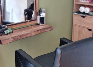 Stylish hairdressing station at TasHair, Blacon, England, GB featuring a mirror and chic styling chair.