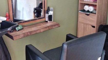 Stylish hairdressing station at TasHair, Blacon, England, GB featuring a mirror and chic styling chair.