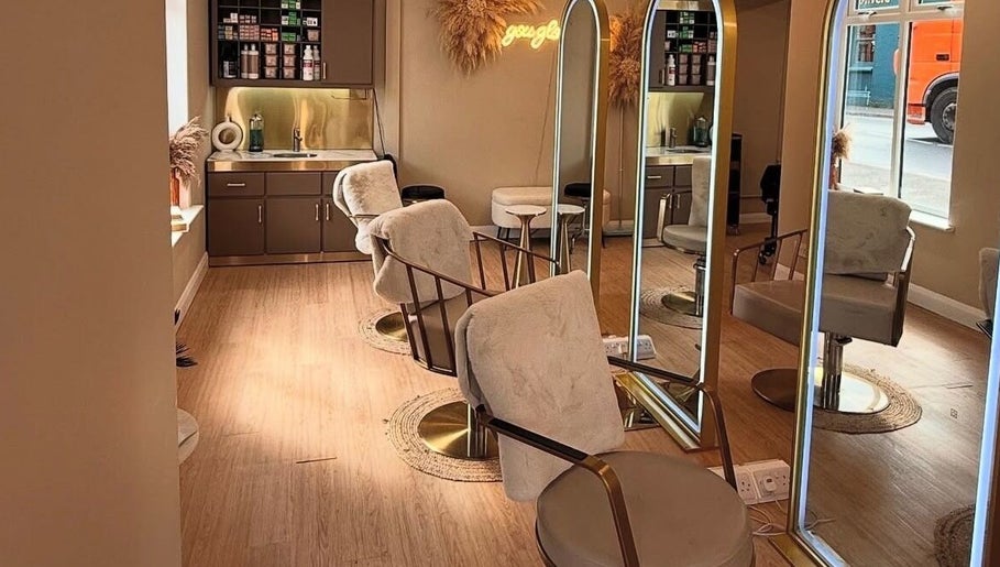 Interior of Laurencoyhair salon in Leicester, England, GB with sleek chairs and large mirrors.