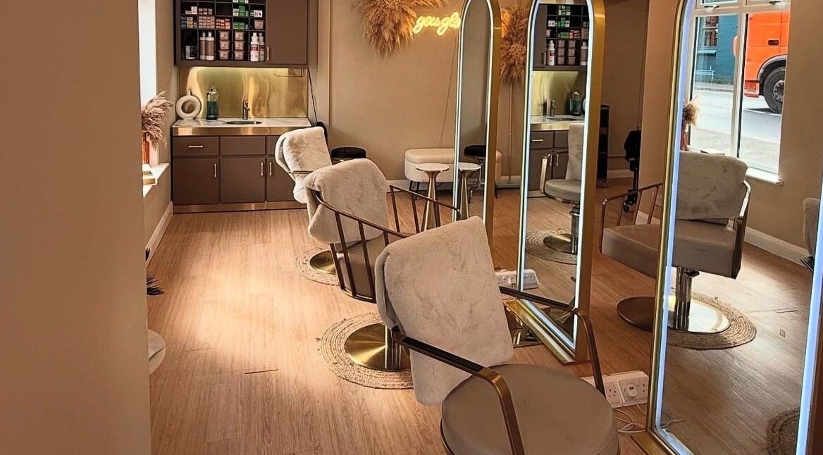 Interior of Laurencoyhair salon in Leicester, England, GB with sleek chairs and large mirrors.