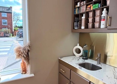 Modern workspace at Laurencoyhair in Leicester, England with stylish décor and hair products.