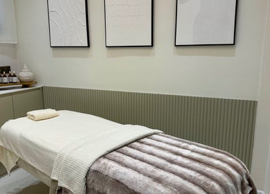 Calm treatment room at Sage and Stone Wellness, Edinburgh, Scotland. Elegant decor with a cozy massage table.