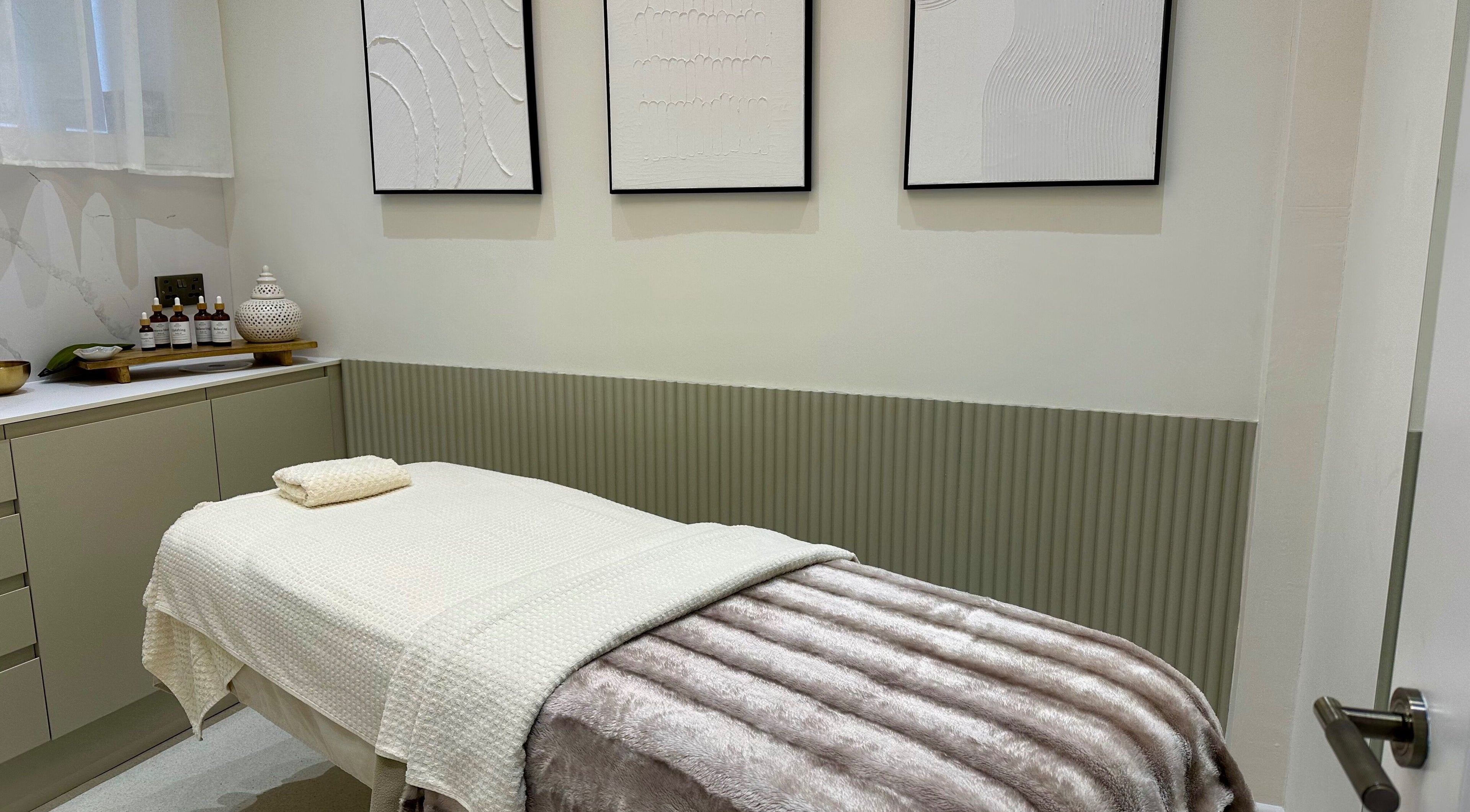 Tranquil treatment room at Sage and Stone Wellness in Edinburgh, Scotland, GB with elegant decor and massage table.