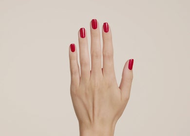 Red manicured nails at Bio Sculpture, London, England, GB, showcasing elegant nail art.