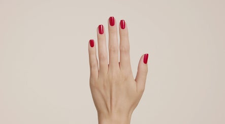 Red manicured nails at Bio Sculpture, London, England, GB, showcasing elegant nail art.
