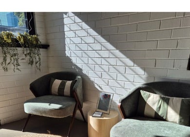 Relaxing lounge chairs at Lash Mode Co., Subiaco, Western Australia, AU with natural light and plants.