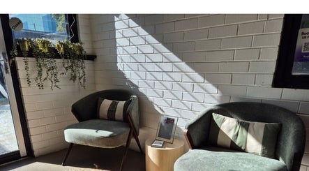 Relaxing lounge chairs at Lash Mode Co., Subiaco, Western Australia, AU with natural light and plants.