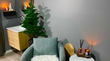 Calm spa corner at Hillside Remedial and Spa, Melbourne, Victoria, AU with chair, candles, and plant.