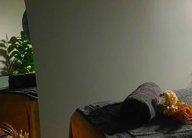 Tranquil massage table at Hillside Remedial and Spa, Melbourne, Victoria, AU with towels and flowers.