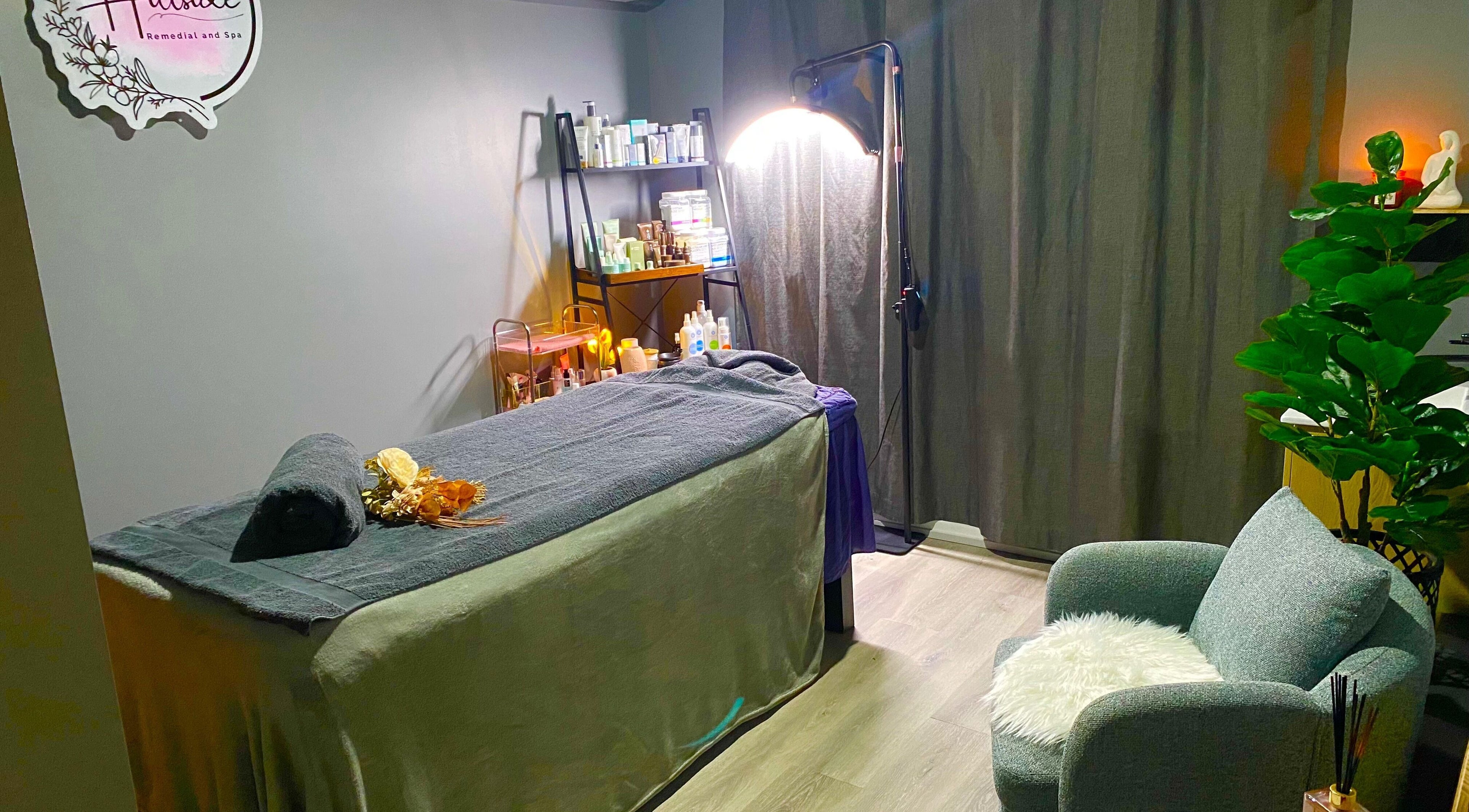Relaxing treatment room at Hillside Remedial and Spa, Melbourne, Victoria, AU with massage bed and cozy chair.