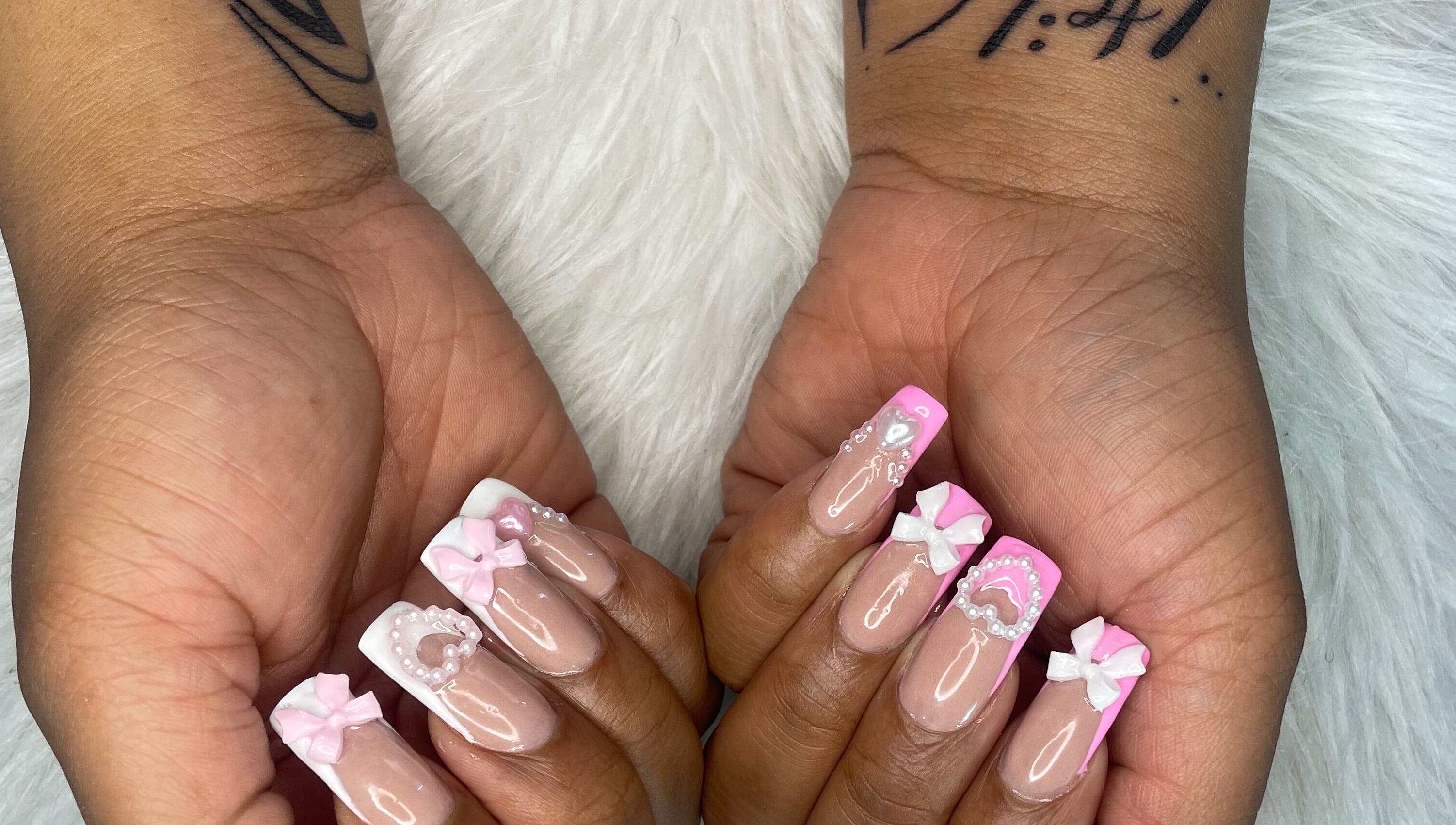 Pink and white bow nail art by Trust Beauty Studio in Randburg, Gauteng, ZA, showcasing detailed manicure design.