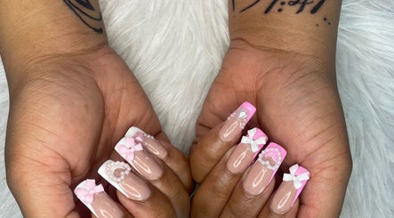 Pink and white bow nail art by Trust Beauty Studio in Randburg, Gauteng, ZA, showcasing detailed manicure design.