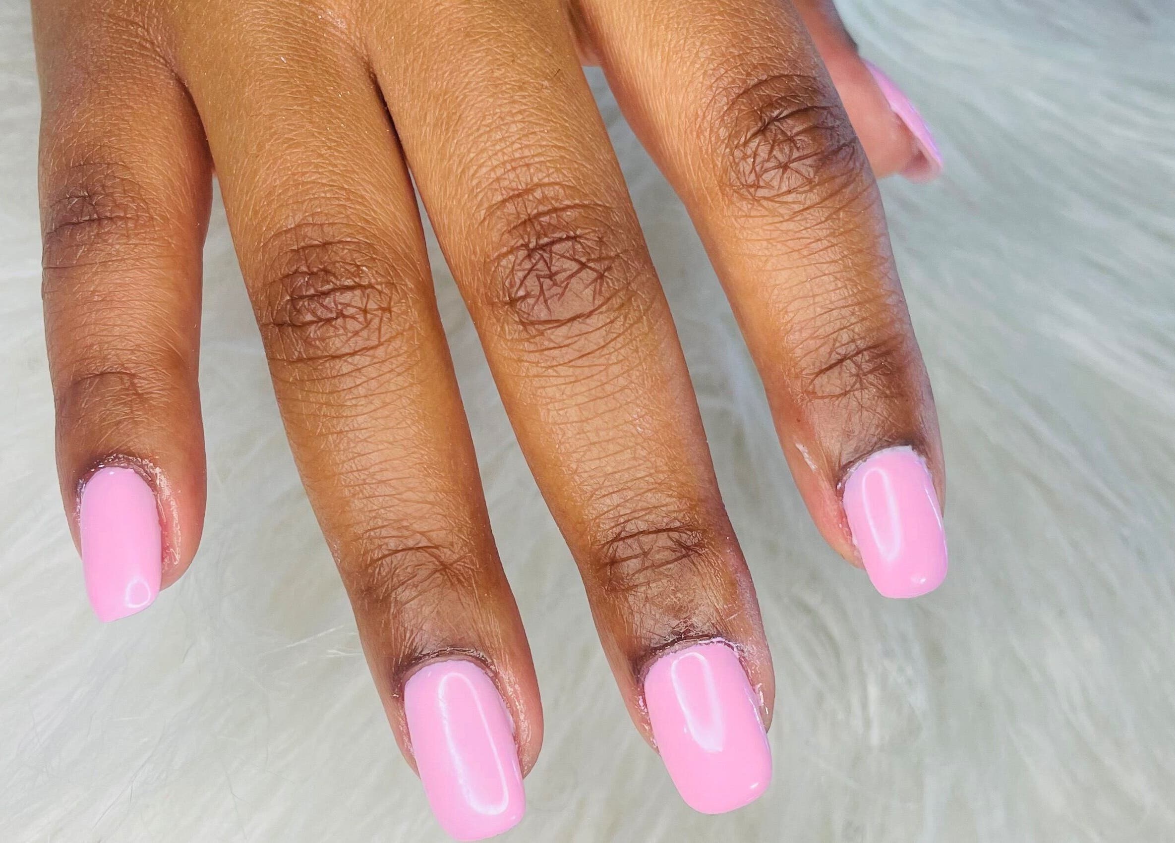 Close-up of manicured nails painted light pink at Trust Beauty Studio, Randburg, Gauteng, ZA.