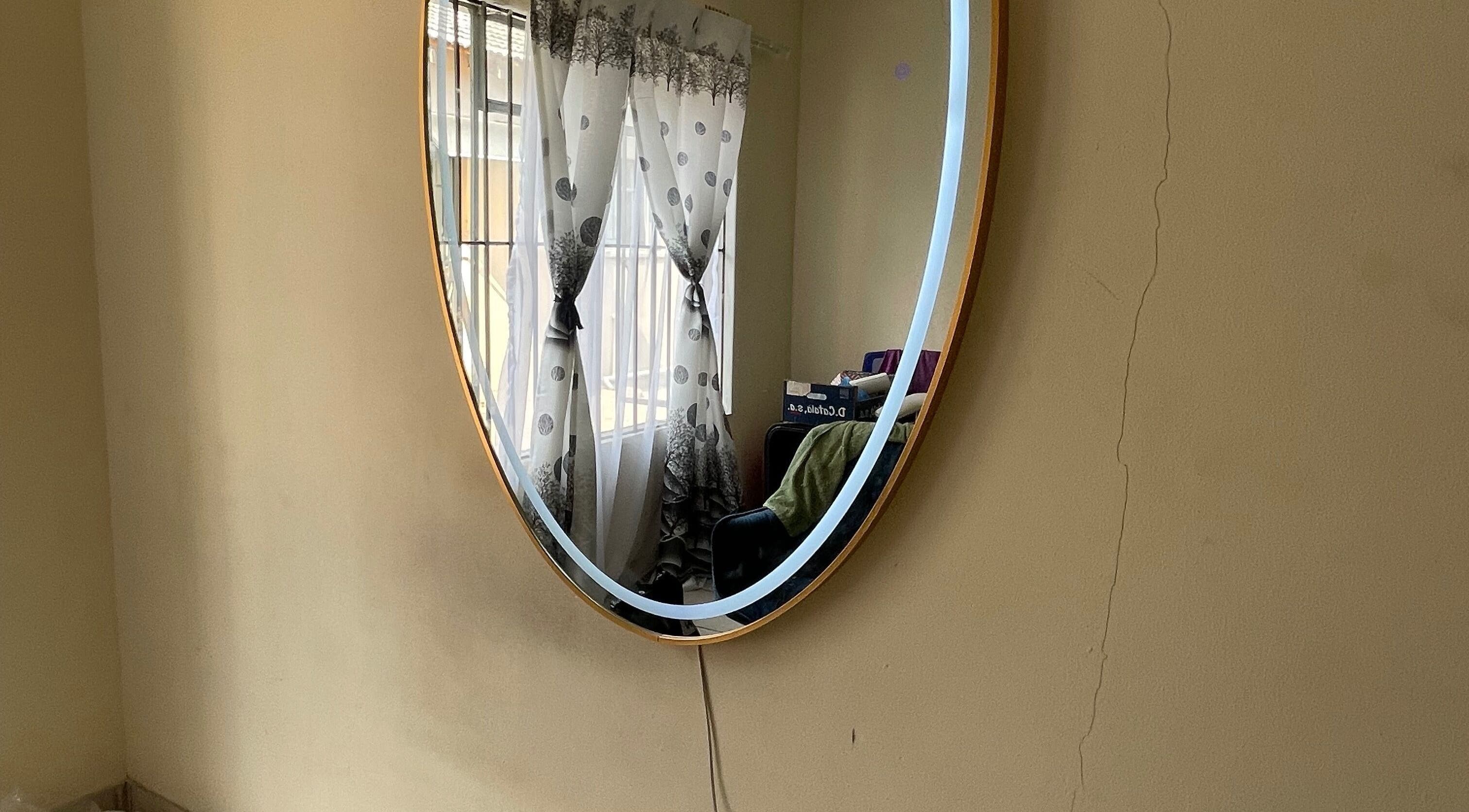 Round mirror at Trust beauty studio, Randburg, Gauteng, ZA adding a touch of elegance to the room.
