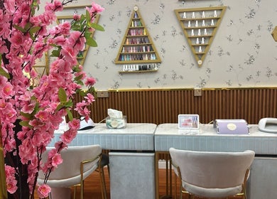 Beauty Bond Salon's elegant manicure station in Riyadh, Riyadh Province, SA, adorned with vibrant pink blossoms.