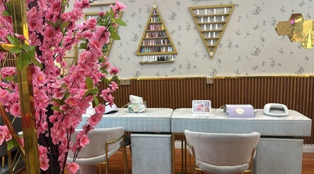 Beauty Bond Salon's elegant manicure station in Riyadh, Riyadh Province, SA, adorned with vibrant pink blossoms.