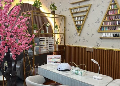 Elegant interior of Beauty Bond Salon, Riyadh featuring chic decor and nail polish display.