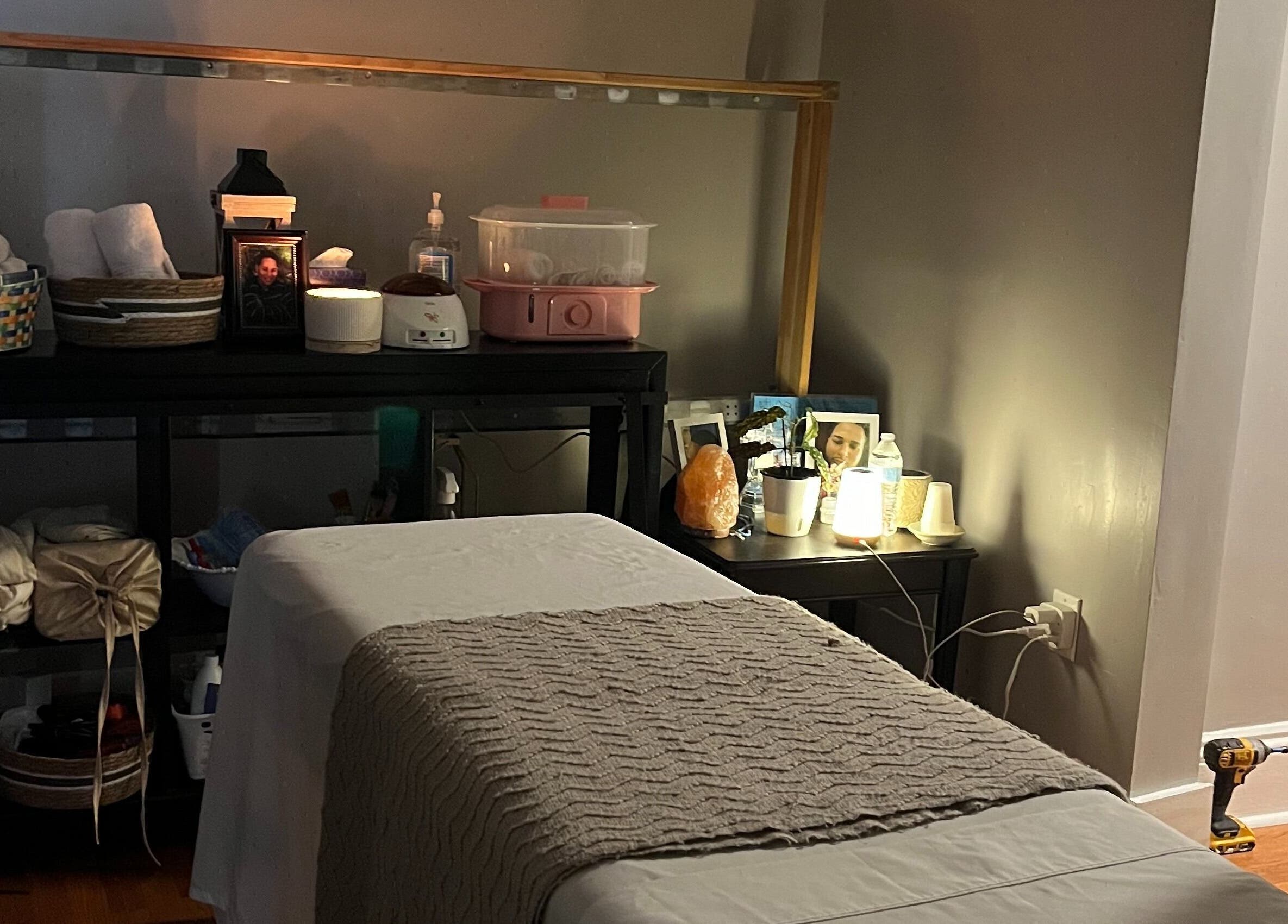 Relaxing massage room at H & A Spa in Cranston, Rhode Island, US, featuring a cozy treatment bed and warm lighting.