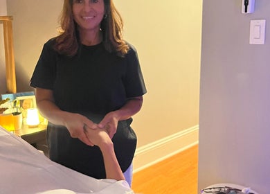 Therapist at H & A Spa in Cranston, Rhode Island, US providing a calming hand massage.